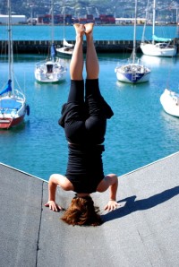 Lauren demonstrates headstand on a blue sky Wellington day